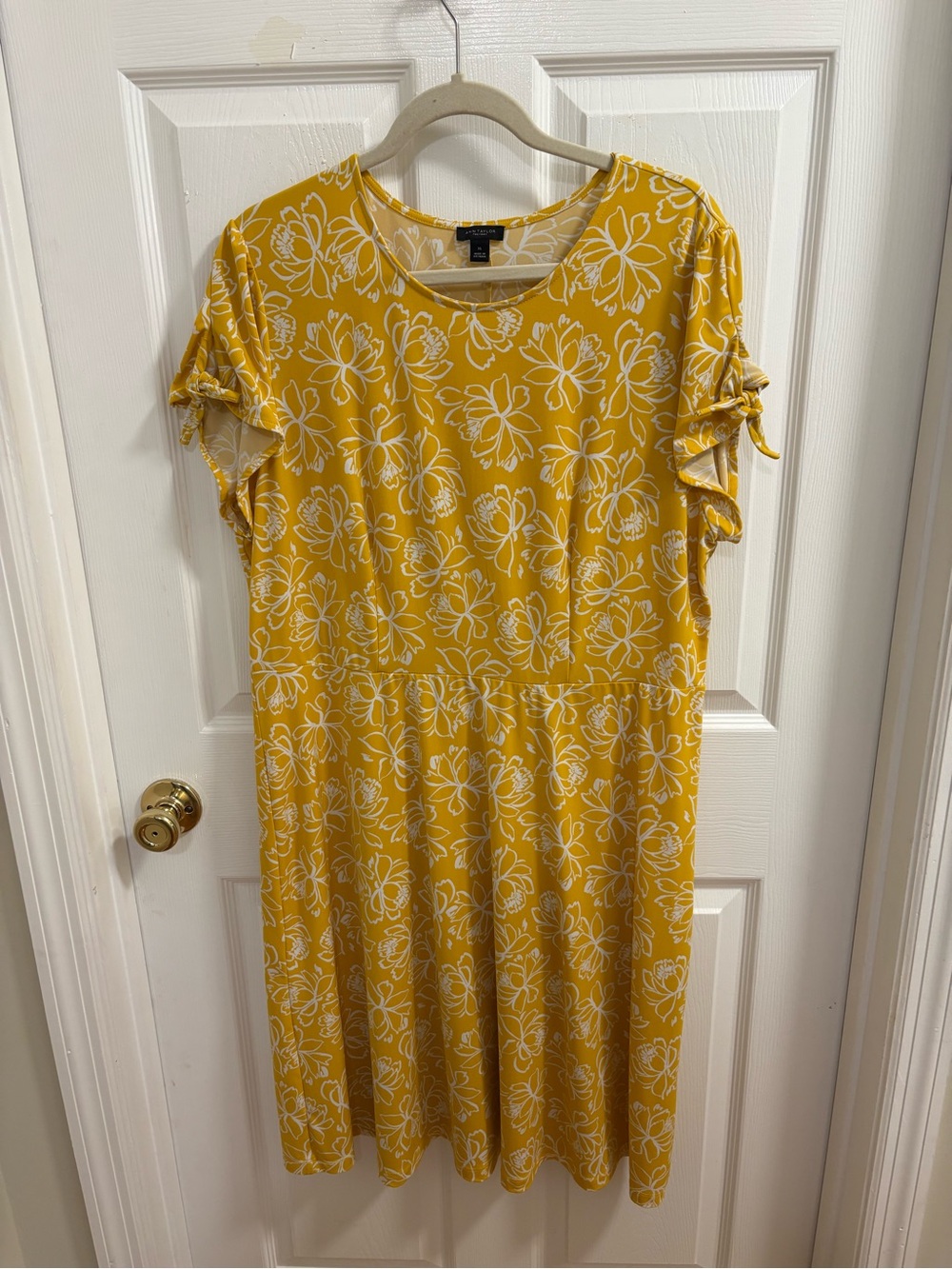 Ann Taylor dress with a vibrant yellow floral pattern and unique tie-sleeves